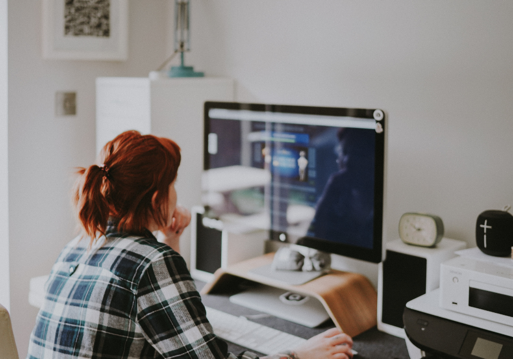 A female using a desktop computer to offer virtual bookkeeping services.