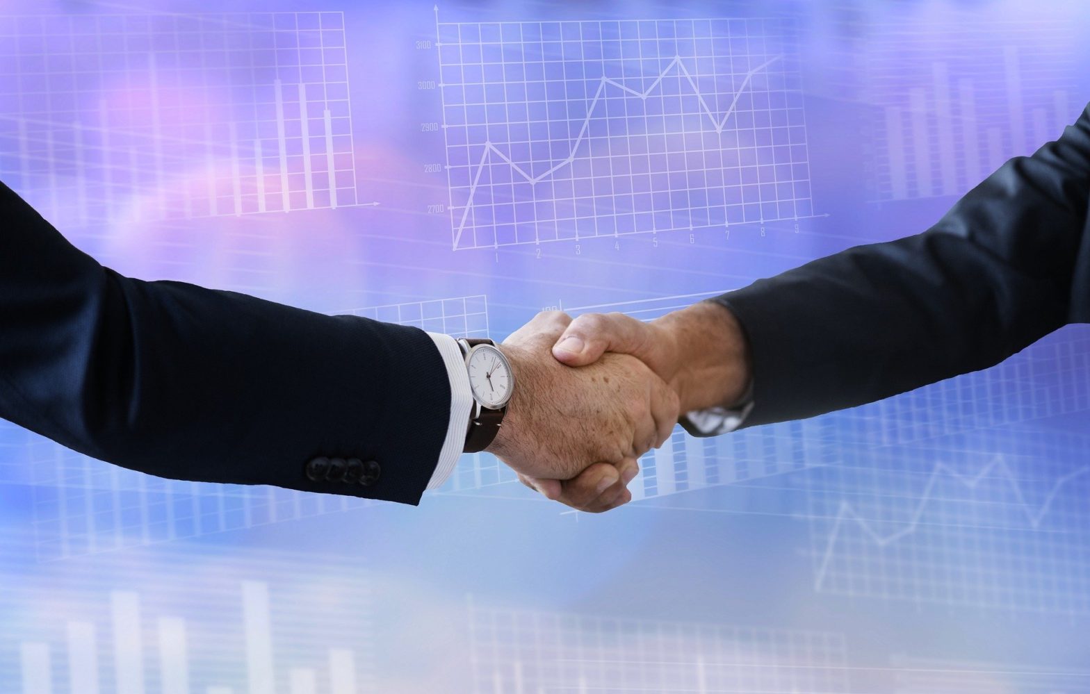 Two men in suits shaking hands against a background of financial charts and graphs.