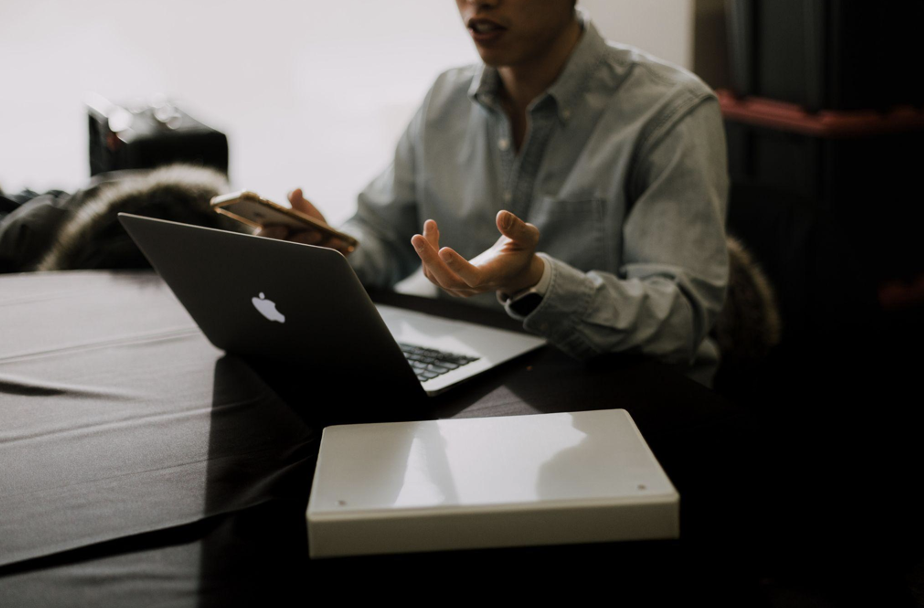A man using a laptop at a desk.