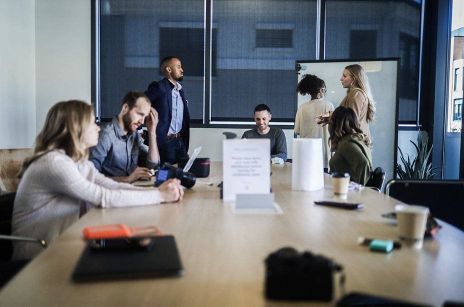 People with laptops and documents working together at a large table. bookkeeping interview questions