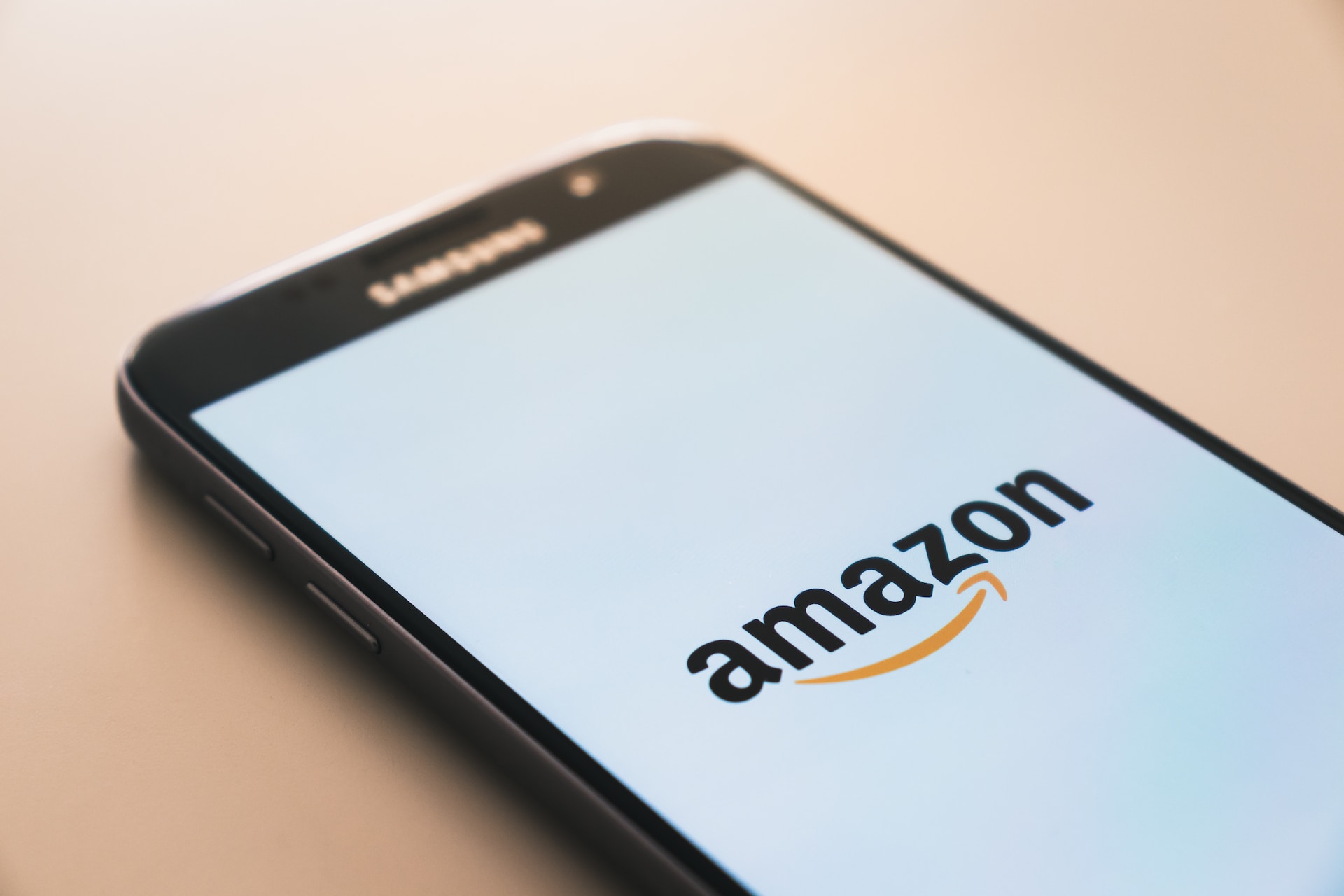 A mobile phone showing the Amazon marketplace logo.