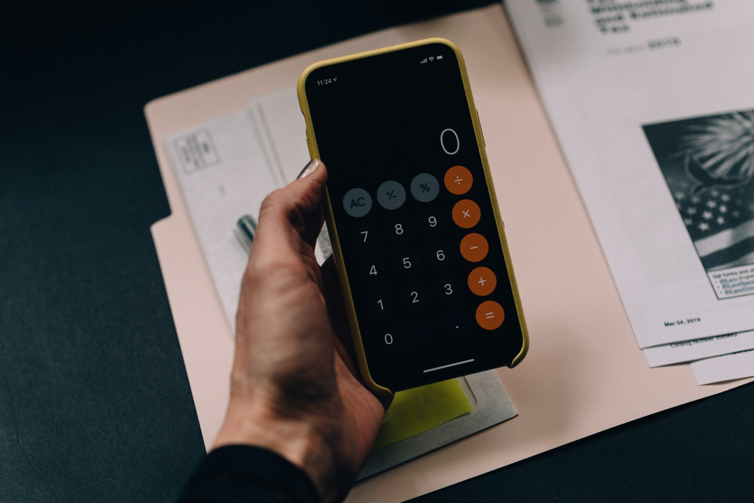 A hand holding a calculator.