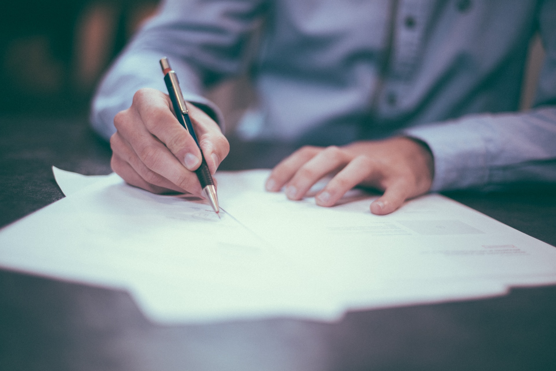 A man filling out Amazon seller tax documents as part of his bookkeeping duties.