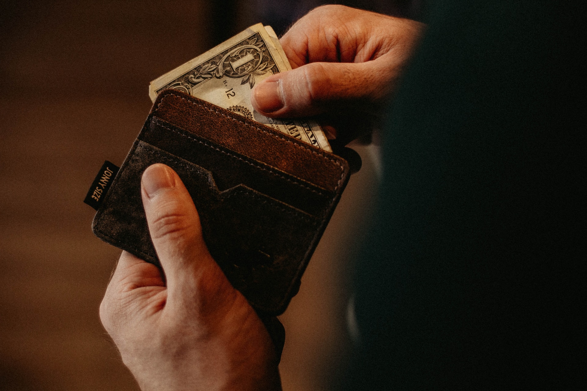 A man taking money out of his wallet.