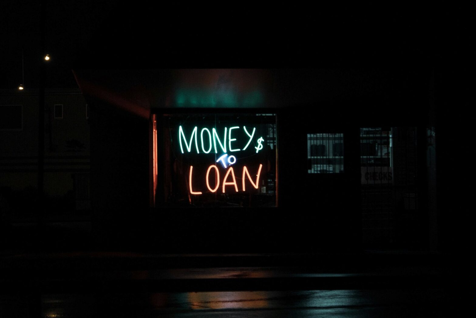 A neon sign that says money to loam.