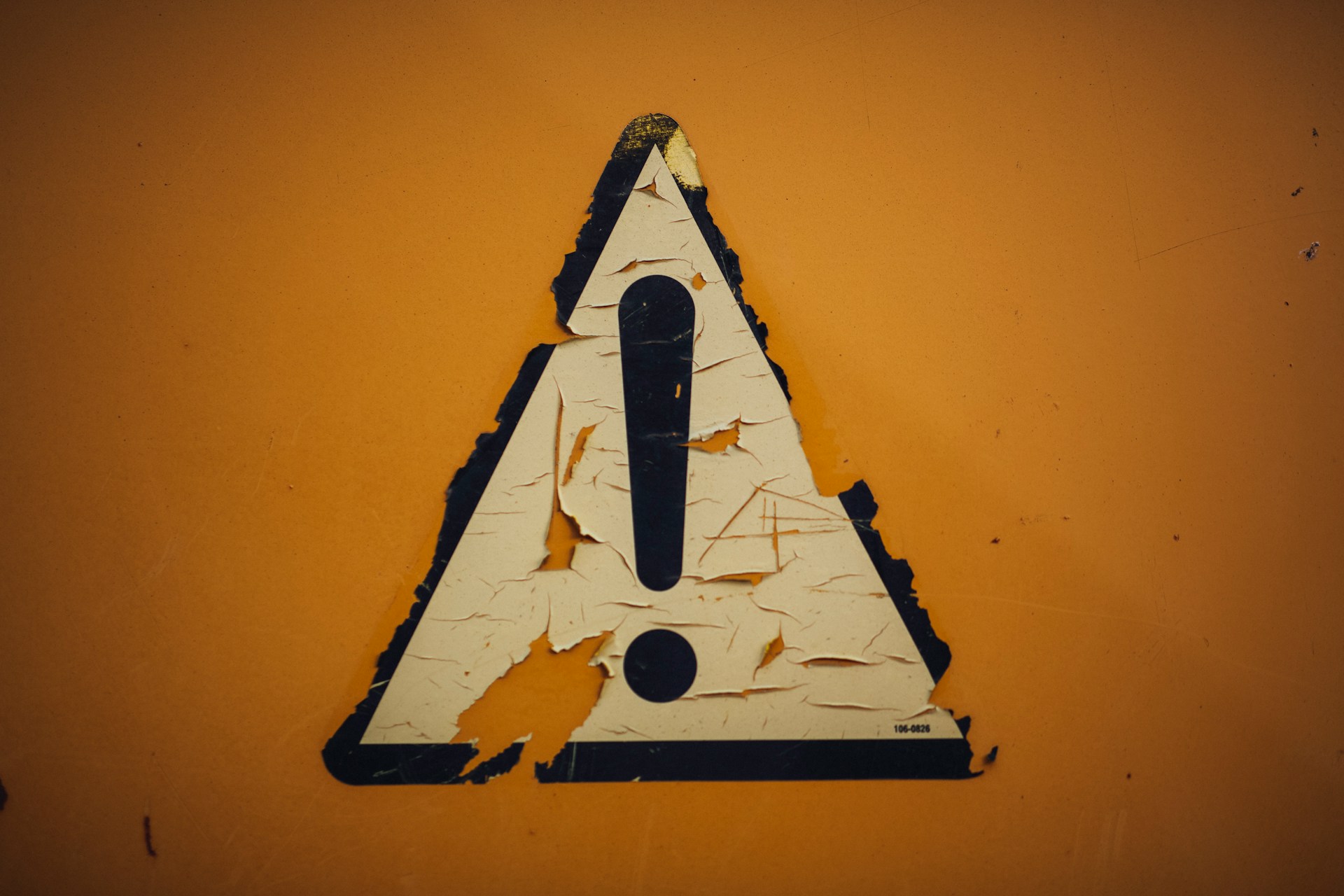 A torn sign showing an exclamation point.