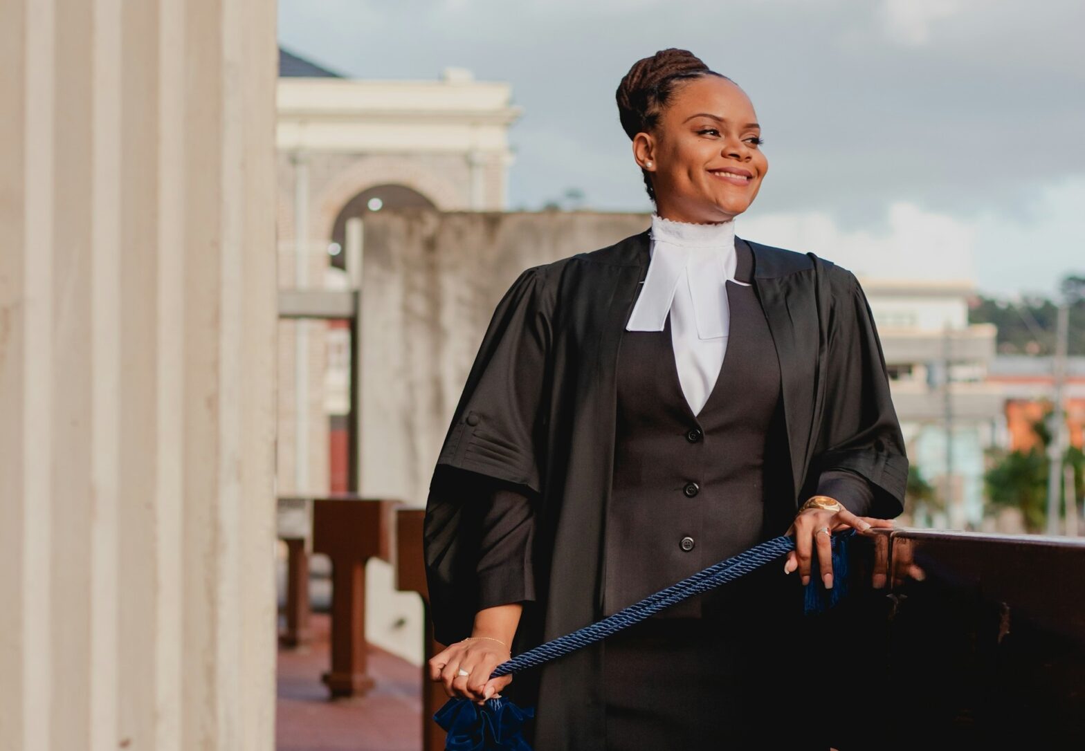 A smiling woman wearing a legal robe.