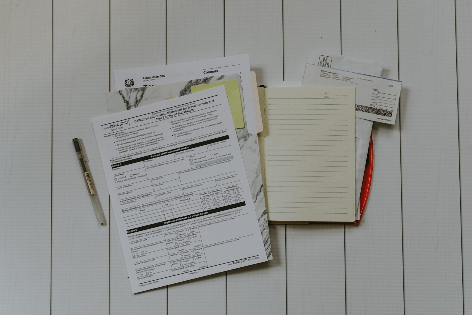 Tax documents in a folder on a table.